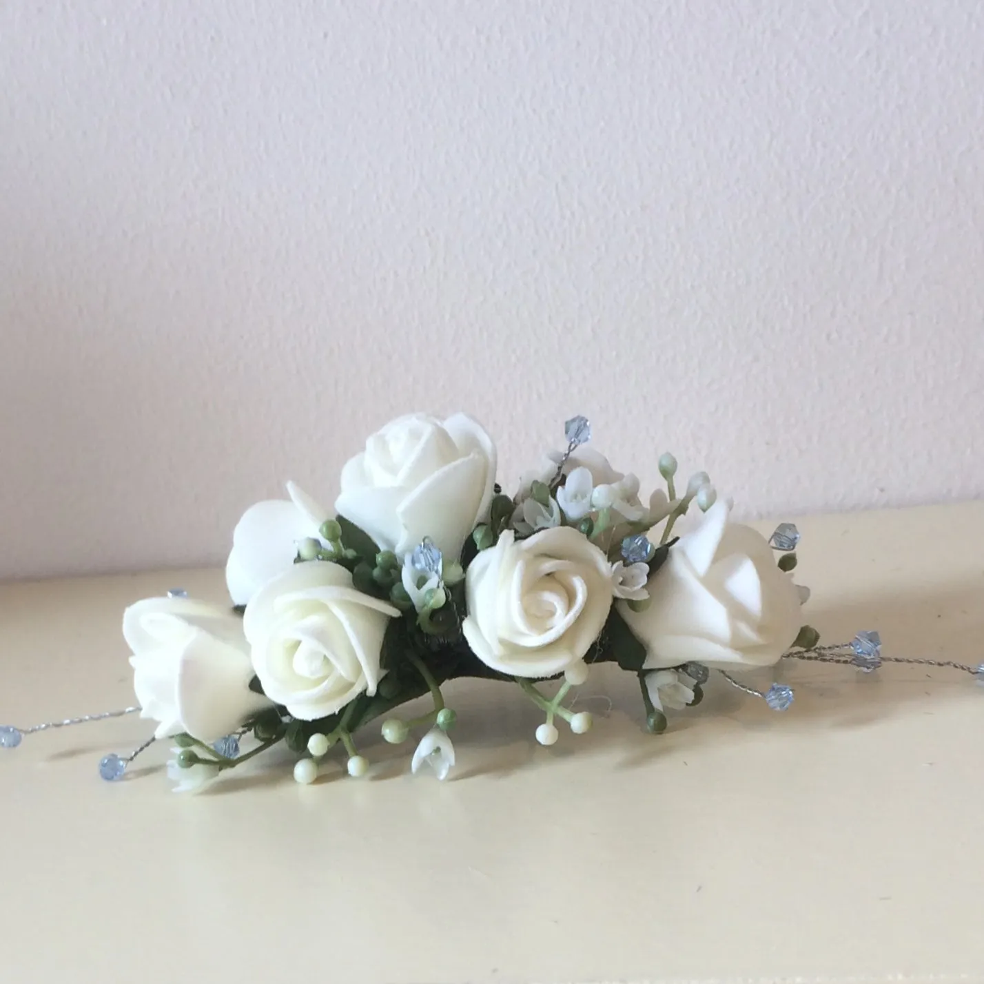 a floral hair comb featuring ivory roses & crystals