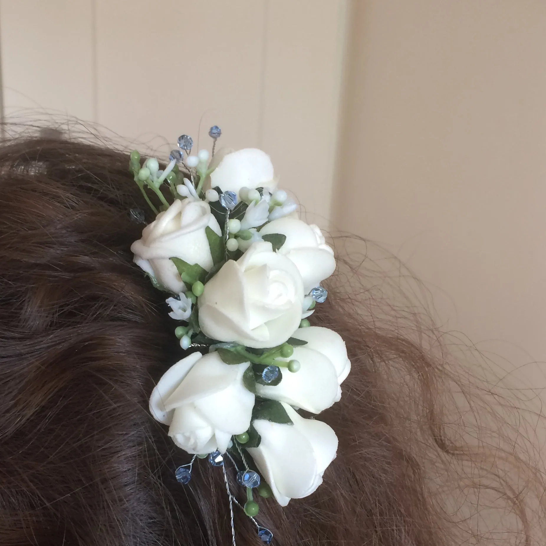 a floral hair comb featuring ivory roses & crystals